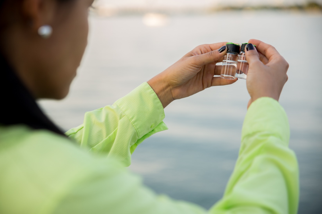 Biscayne Bay Water Samples being held up by a student