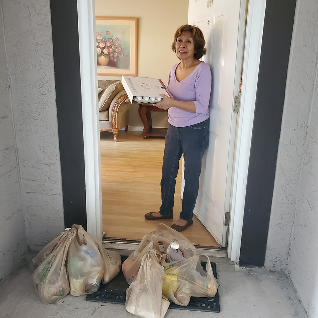 Women receiving groceries delivered