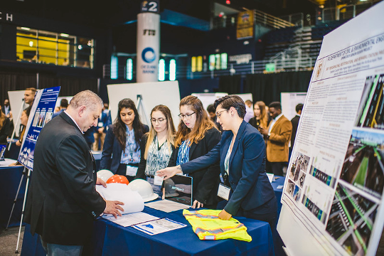 Four CEC students presenting at a table