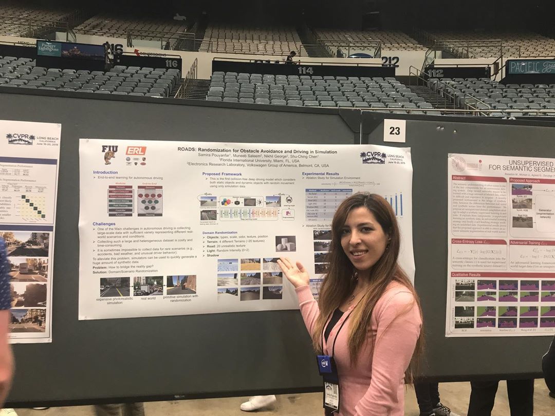 Samira a student in the SCIS program posing in front of her presentation board for an undergraduate research fair