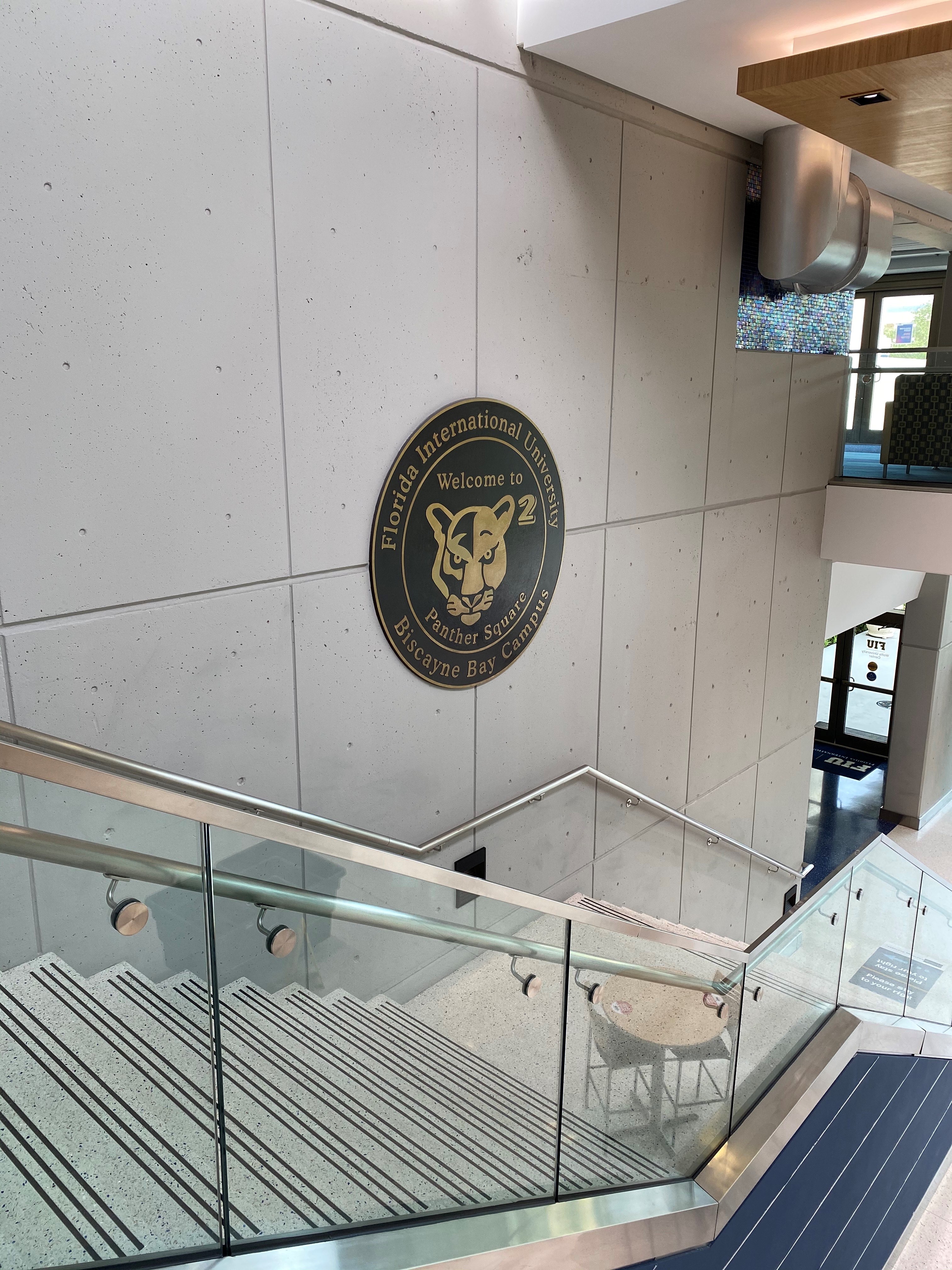 Florida International University Biscayne Bay Campus Official Seal, a circular seal that has FIU written across the top and BBC on the bottom and in the center is a large panther face staring with a direct and none aggressive face  